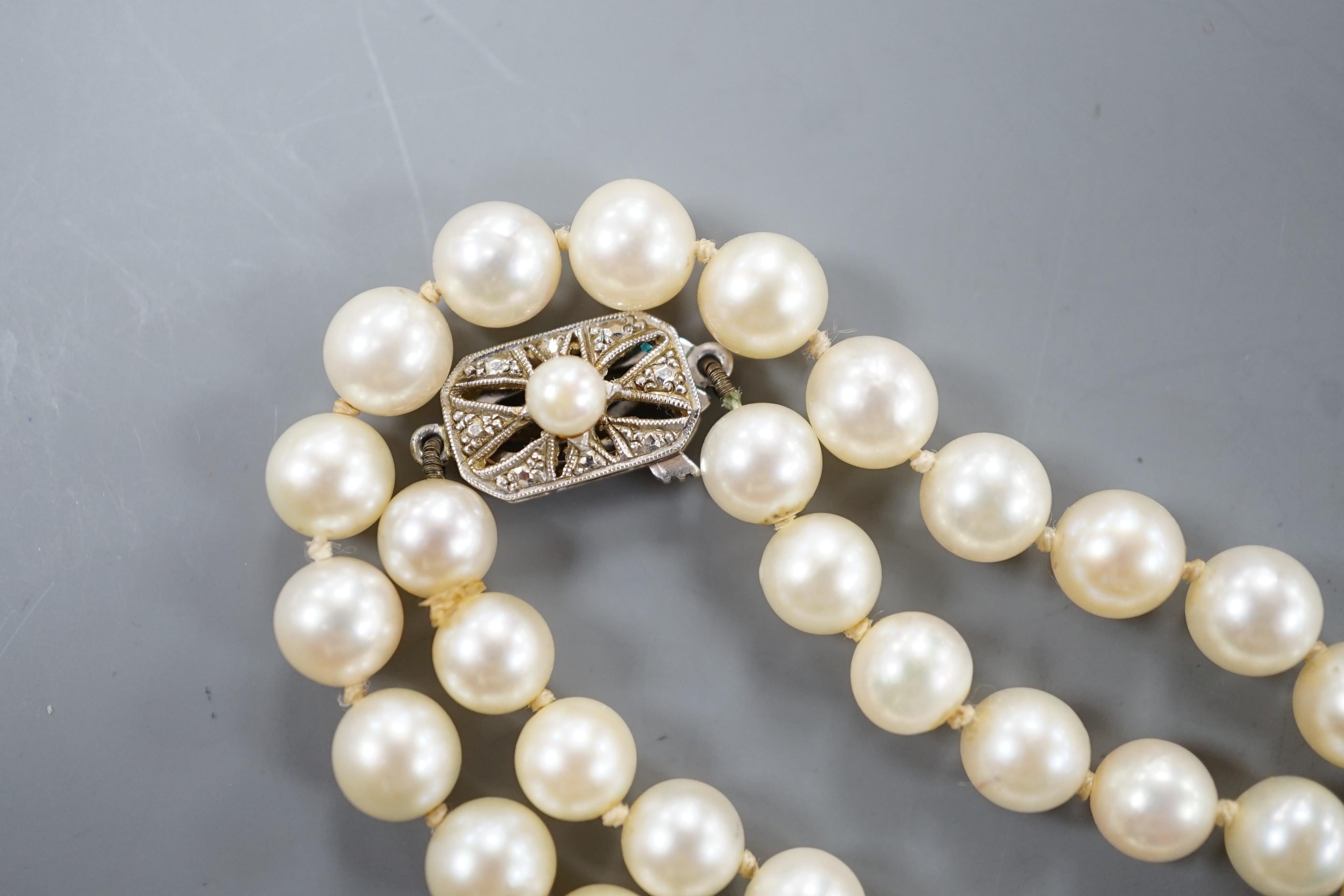 A long single strand cultured pearl necklace with cultured pearl set 9ct white gold clasp, 75cm.